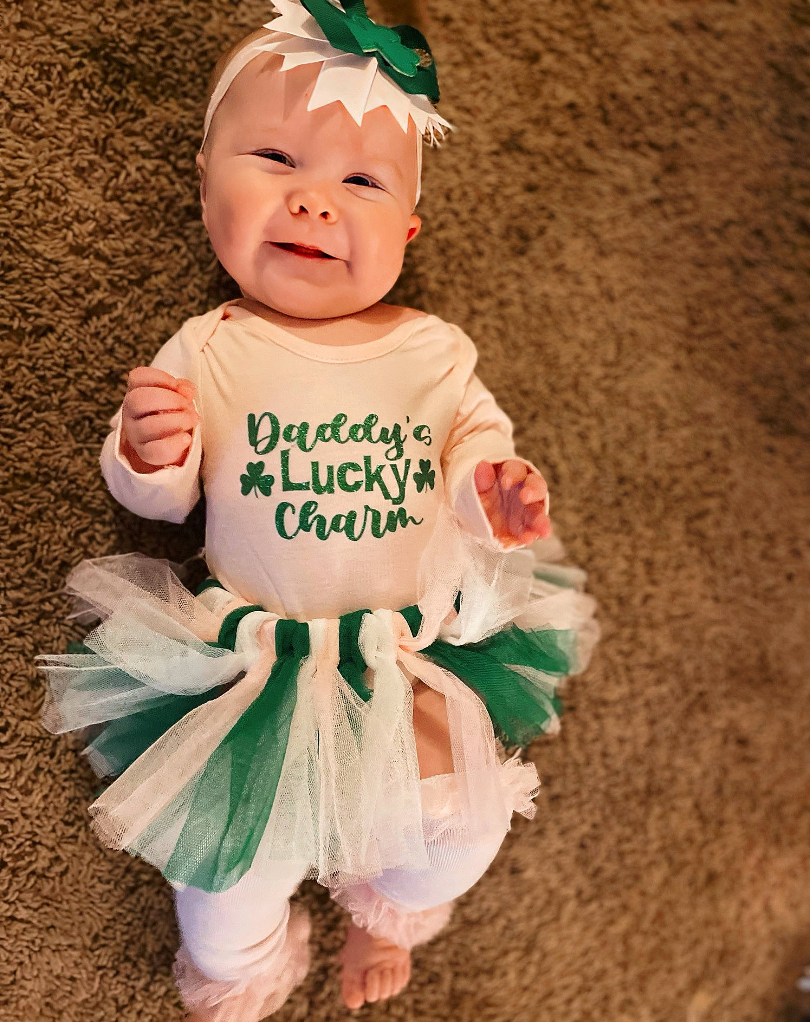 Brystol is registered to the contest to win money with this photo: baby, baby_products, baby_toddler_clothing, child, clothing, costume_hat, dress, face, fashion_accessory, fictional_character, grass, happy, head, headpiece, headwear, human_body, person, pink, sleeve, smile