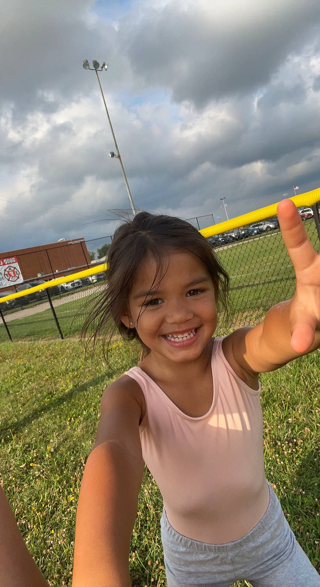 Penelope is registered to the contest to win money with this photo: child, cloud, field, fun, grass, grassland, happy, joy, landscape, leisure, people_in_nature, person, pole, prairie, recreation, sky, smile, toddler, travel, vacation