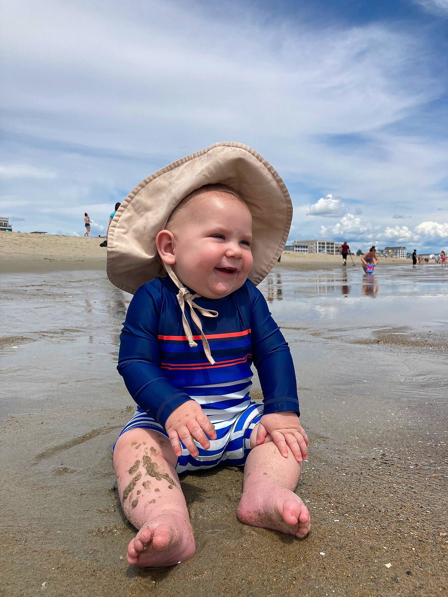 Henry is registered to the contest to win money with this photo: baby, baby_toddler_clothing, barefoot, beach, cloud, coastal_and_oceanic_landforms, flash_photography, foot, happy, hat, landscape, people_in_nature, people_on_beach, person, sand, shore, sky, sun_hat, toddler, travel