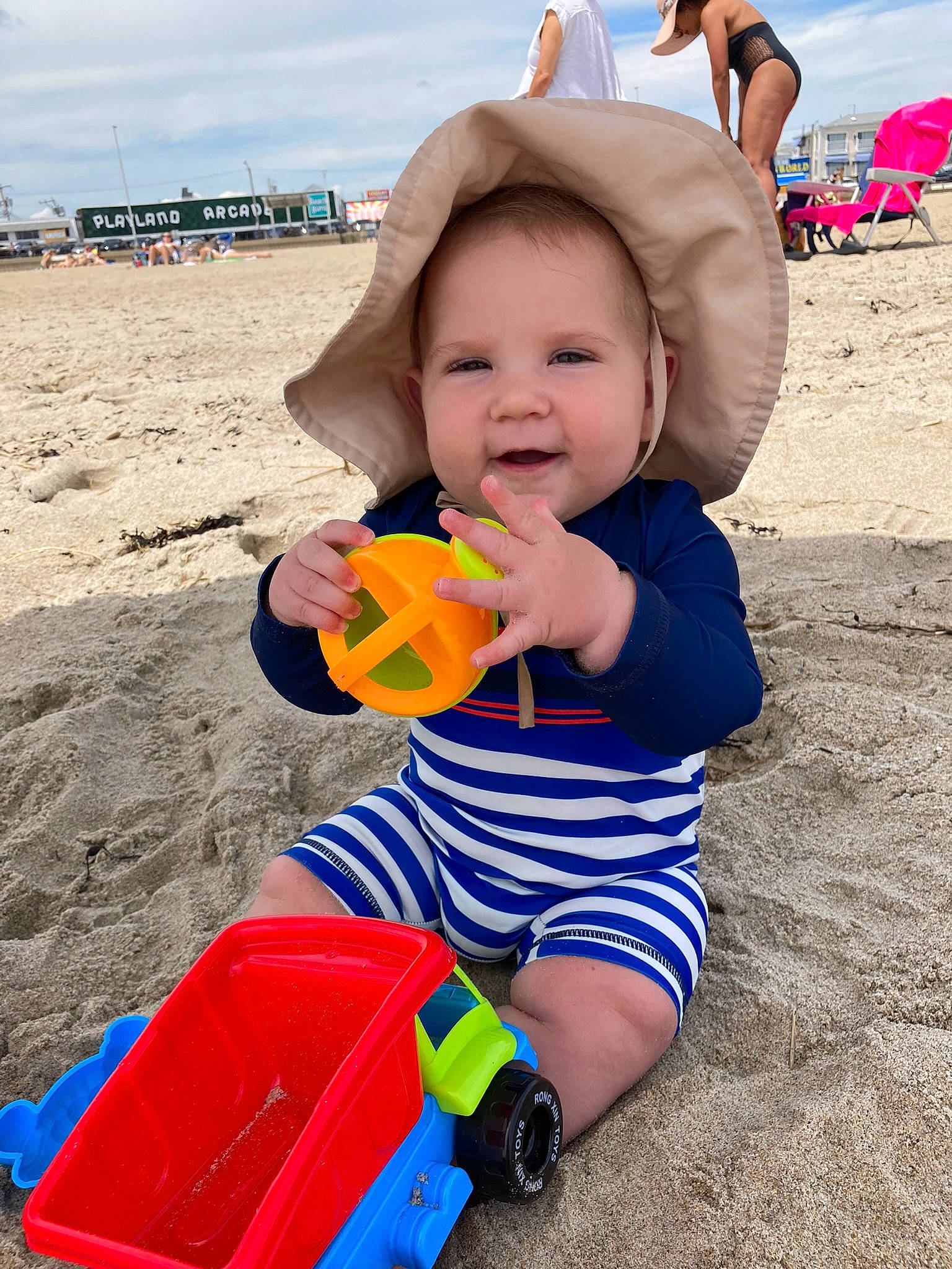 Henry joined the competition — help win amazing prizes! baby, baby_playing_with_toys, baby_toddler_clothing, beach, child, cloud, fun, happy, hat, leisure, people_in_nature, people_on_beach, person, photograph, recreation, sky, smile, sun_hat, toddler, toy