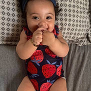 Denali Selah joined the competition — help win amazing prizes! baby, infant, smiling, headband, strawberry_pattern, onesie, lying_down, bed, pillow, happy, cute, child, skin, hand, face, person, indoors, young, playful, bracelet