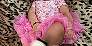 Denali Selah joined the competition — help win amazing prizes! baby, child, pink_tutu, headband, tongue_out, leopard_print, blanket, footwear, smiling, happy, cute, infant, motion_blur, bracelet, playful, indoors, portrait, one_person, clothing, soft_texture
