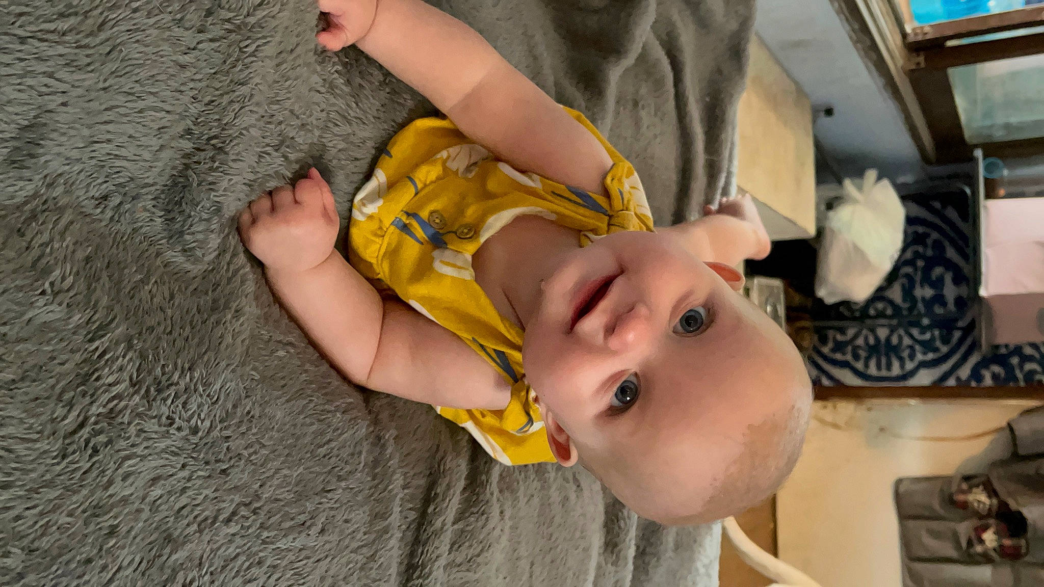 Eloise is registered to the contest to win money with this photo: baby, baby_products, baby_toddler_clothing, cheek, child, ear, eyelash, finger, flooring, fun, gesture, hand, happy, human_body, joy, nail, person, skin, smile, thumb