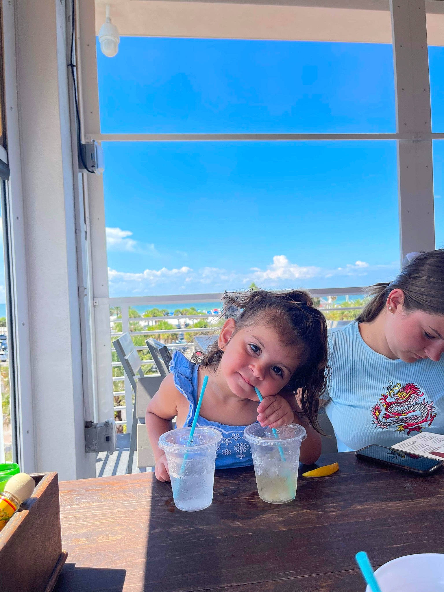 Mila joined the competition — help win amazing prizes! alcoholic_beverage, chair, cloud, cocktail, drink, drinking, event, fun, happy, leisure, person, plate, recreation, sky, smile, summer, t_shirt, table, tableware, travel