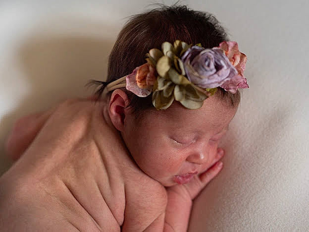 Baylee is registered to the contest to win money with this photo: baby, baby_toddler_clothing, bathing, bridal_accessory, child, comfort, costume_hat, ear, fashion_accessory, flower, hair_accessory, headband, headgear, headpiece, headwear, linens, magenta, person, petal, plant