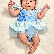 Angelique joined the competition — help win amazing prizes! baby, infant, child, blue_dress, headband, bow, smiling, lying_down, white_background, cute, portrait, tutu, sleeveless, soft_fabric, barefoot, young_child, adorable, one_person, indoor, human