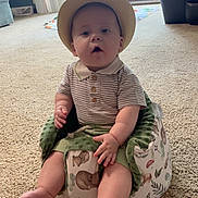 Garrett joined the competition — help win amazing prizes! baby, child, hat, striped_shirt, baby_seat, carpet, indoor, living_room, footwearless, chubby_cheeks, furniture, door, patio, window, plush, cute, person, sitting, infant, comfortable