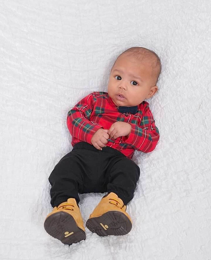 Kayson joined the competition — help win amazing prizes! baby, baby_toddler_clothing, carmine, child, collar, eye, footwear, fur, head, human_body, knee, pattern, person, plaid, sandal, sitting, sleeve, sock, thigh, toddler