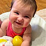 Ayla joined the competition — help win amazing prizes! baby, child, smiling, pink_bow, yellow_ball, blanket, cushion, wooden_floor, indoors, happy, cute, infant, portrait, playful, clothing, bracelet, face, person, hand, soft