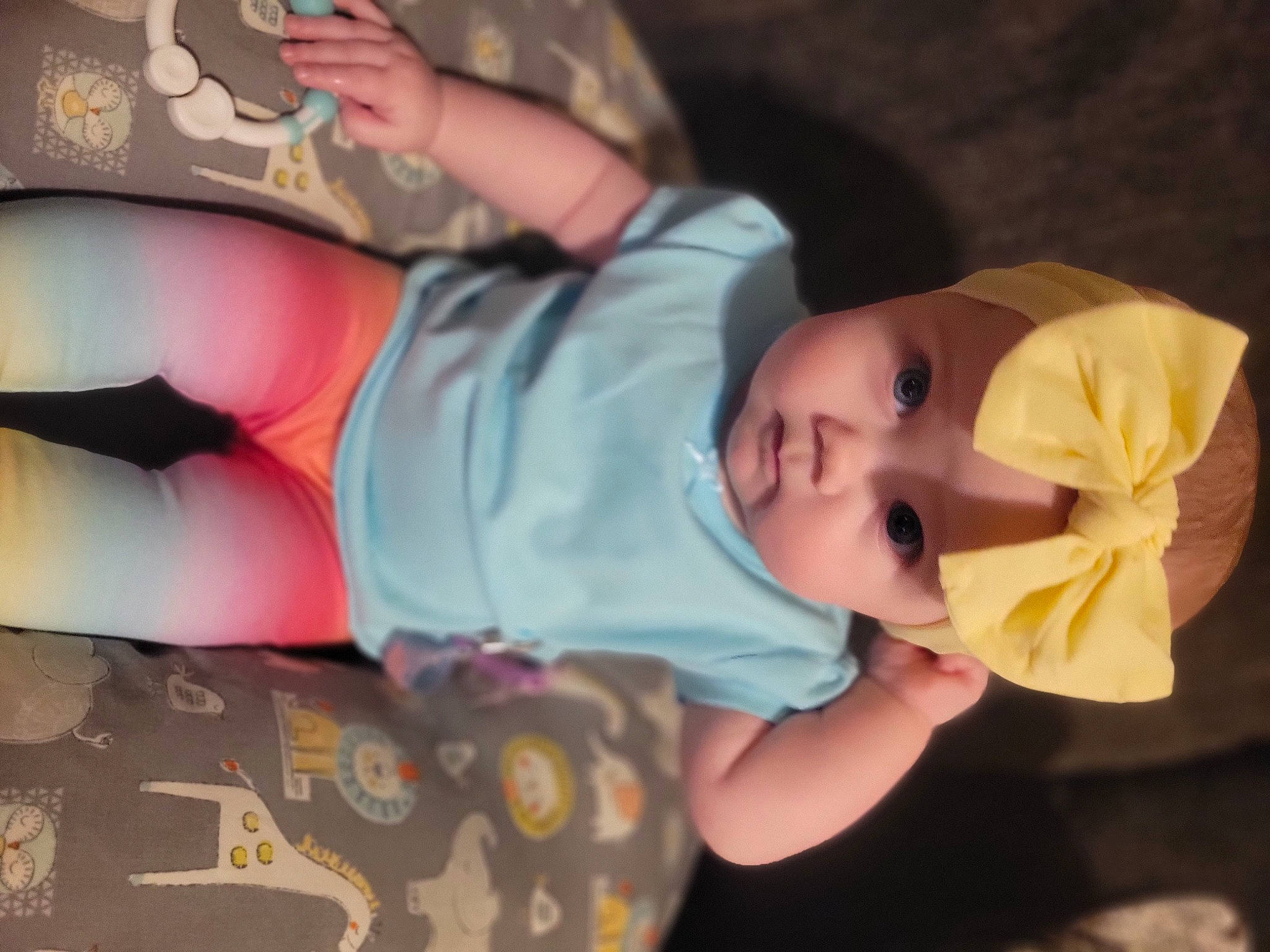 Trinity is registered to the contest to win money with this photo: arm, baby, baby_toddler_clothing, child, elbow, finger, fun, headwear, human_body, human_leg, mouth, nail, orange, pattern, person, pink, skin, sleeve, textile, thigh