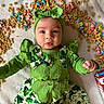 Treazure is registered to the contest to win money with this photo: baby, infant, green_clothing, headband, shamrock, cereal, lucky_charms, food, box, lying_down, cute, face, child, colorful, soft_surface, playful, expression, portrait, holiday_theme, st_patricks_day