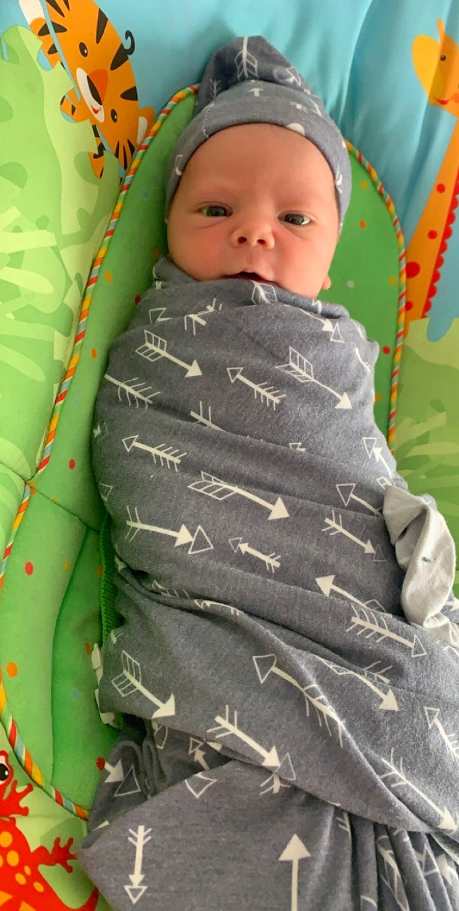 Dane is registered to the contest to win money with this photo: baby, baby_toddler_clothing, cheek, child, eye, face, facial_expression, grass, green, head, human_body, linens, military_camouflage, pattern, people_in_nature, person, photograph, skin, sleeve, terrestrial_plant