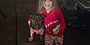 Binx And Moana joined the competition — help win amazing prizes! child, dog, pajamas, couch, lamp, plush_toy, holiday, grinch, smile, indoor, brown_furniture, barefoot, toy, red_clothing, wood_floor, small_dog, blonde_hair, happy, living_room, person