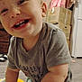Ransom is registered to the contest to win money with this photo: toddler, child, smiling, baby, indoor, grey_shirt, happy, face, teeth, crawling, floor, cardboard_boxes, household, furniture, wooden_floor, person, casual_clothing, cute, playful, young_child