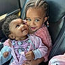 baby, toddler, child, car_seat, braided_hair, pink_clothing, hello_kitty, onesie, fuzzy_jacket, cute, smiling, happy, indoor, portrait, people, infant, car_interior, black_hair, holding, seated