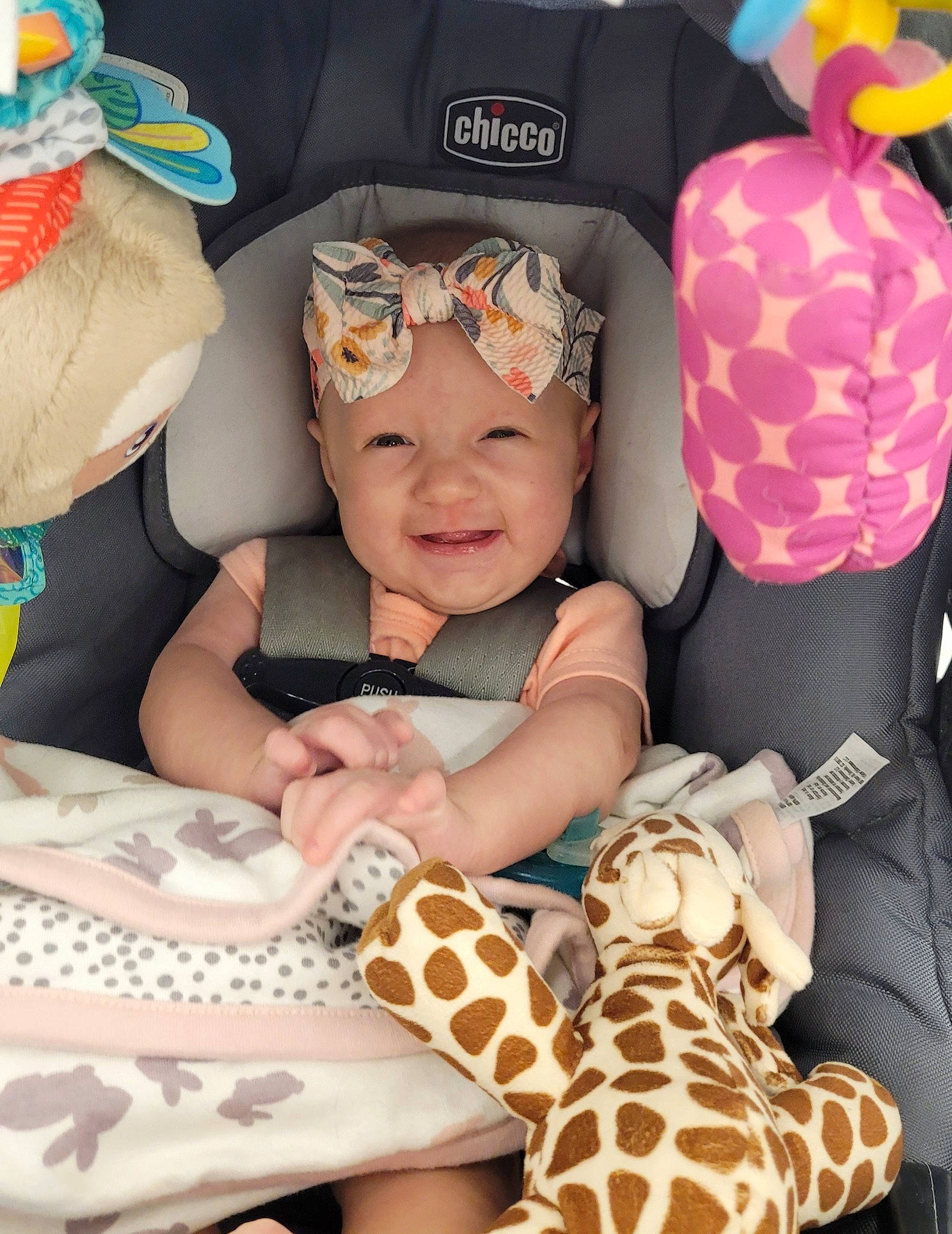 Kinsley is registered to the contest to win money with this photo: baby, baby_toddler_clothing, child, comfort, eye, eyewear, face, fawn, finger, fun, giraffidae, hat, head, headwear, mouth, orange, organ, person, pink, skin