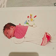 Phylomene a rejoint le concours — aidez-le/la à gagner de superbes lots ! newborn, baby, sleeping, knitted_clothing, pink, white, stuffed_toy, unicorn, soft, resting, infant, cute, portrait, lying_down, child, cozy, warm, toy, peaceful, background