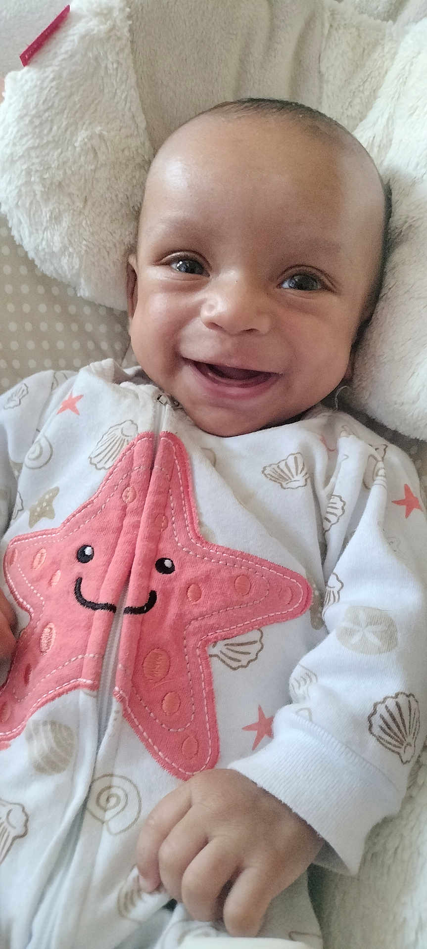 Nahzir joined the competition — help win amazing prizes! baby, infant, smile, happy, onesie, starfish, shell_pattern, hand, blanket, cozy, cute, face, child, soft_texture, sleepwear, lying_down, closeup, indoors, comfort, adorable