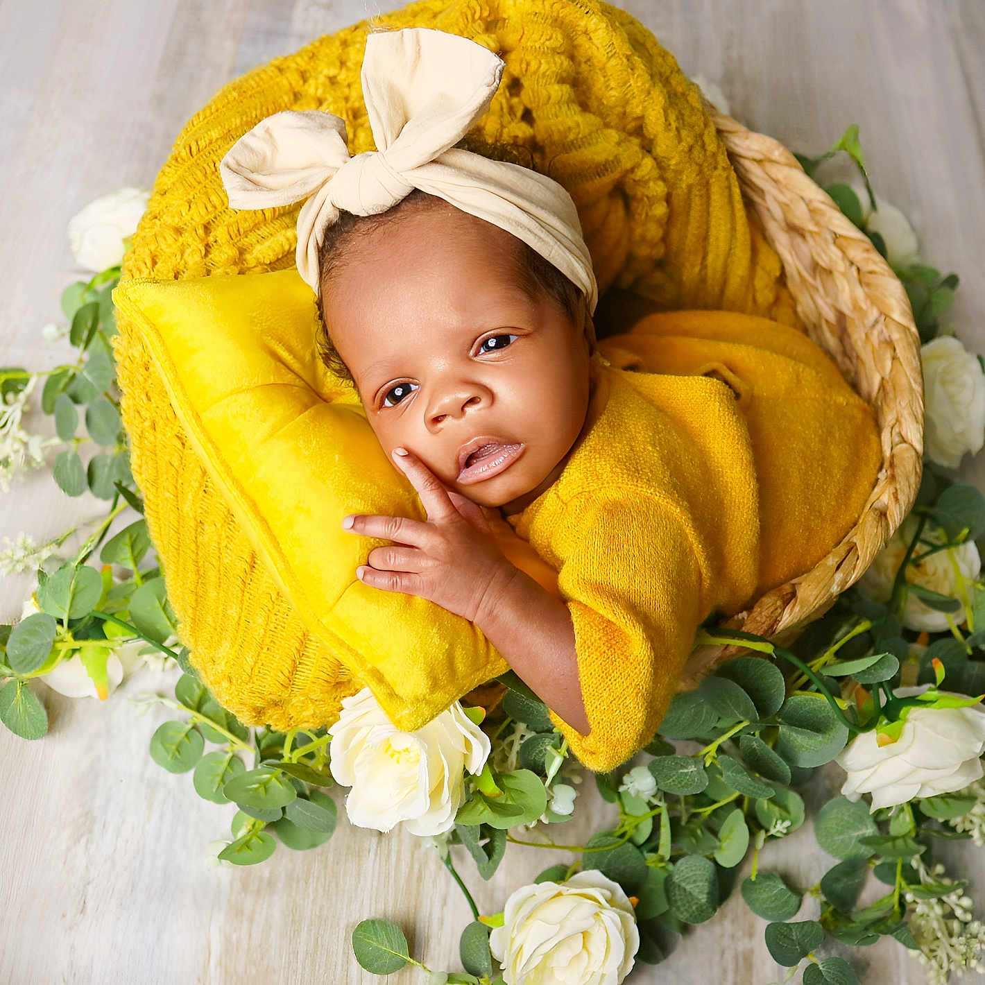 Rayne is registered to the contest to win money with this photo: baby, basket, blanket, bow, child, cute, flower, greenery, headband, indoor, infant, laying_down, natural_light, newborn, peaceful, pillow, portrait, soft_texture, wooden_floor, yellow_clothing