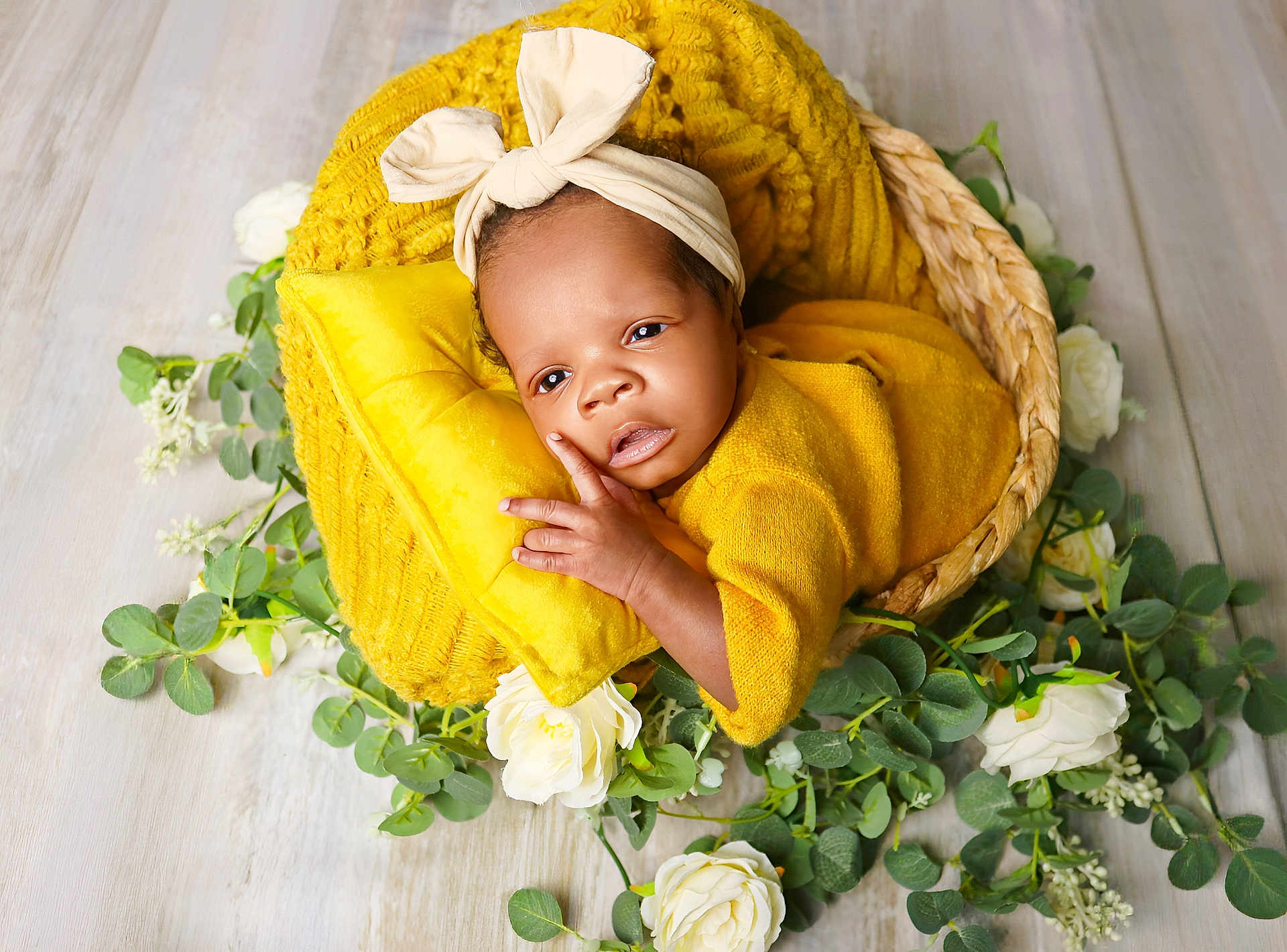 Rayne is registered to the contest to win money with this photo: baby, basket, blanket, bow, child, cute, flower, greenery, headband, indoor, infant, laying_down, natural_light, newborn, peaceful, pillow, portrait, soft_texture, wooden_floor, yellow_clothing