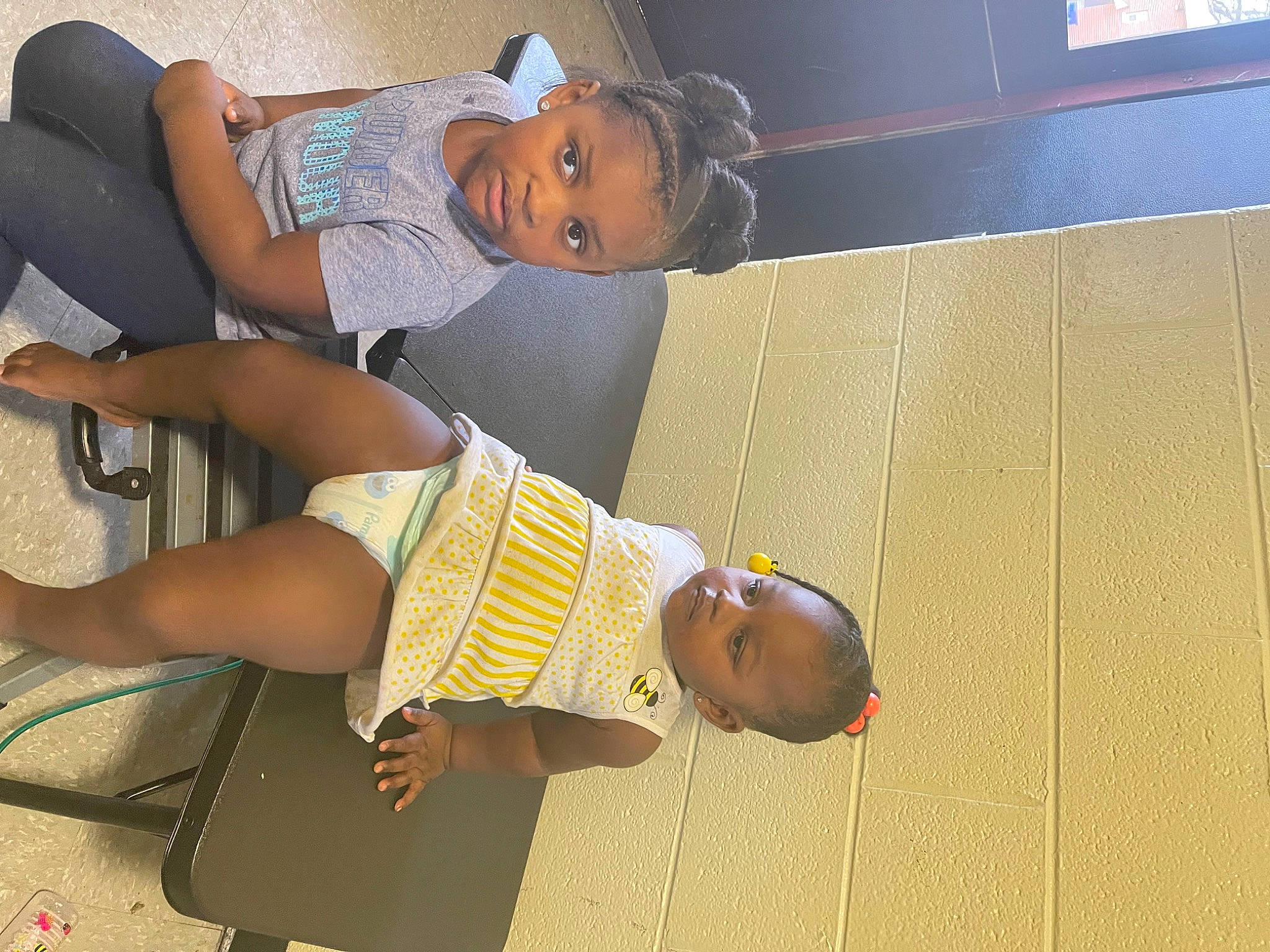 Ava is registered to the contest to win money with this photo: arm, baby_toddler_clothing, child, comfort, elbow, finger, foot, fun, hat, human_leg, knee, leg, person, room, shorts, sitting, sock, t_shirt, thigh, toddler