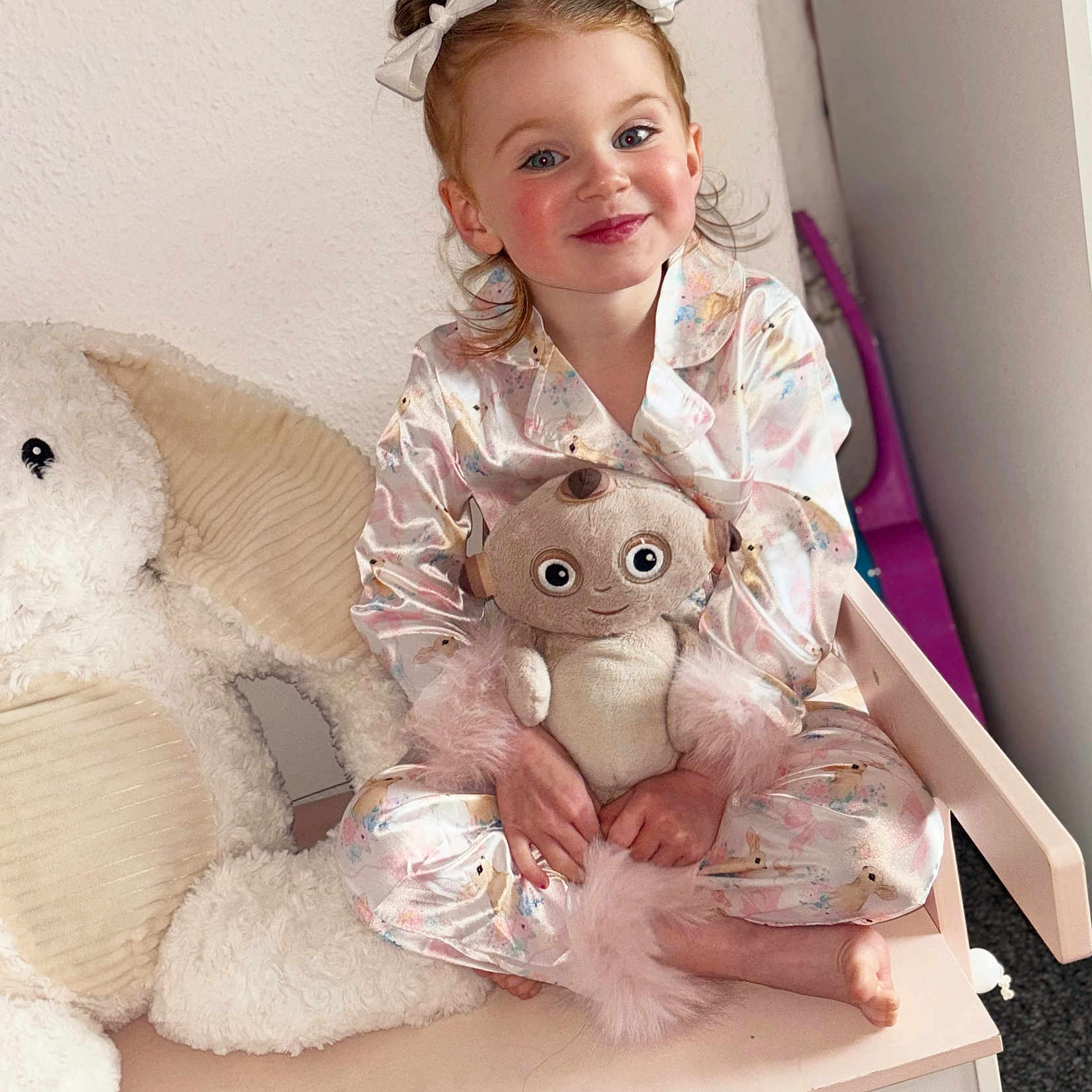 Tyne is registered to the contest to win money with this photo: bench, child, childhood, cozy, cute, elephant, girl, hair_buns, happy, indoor, pajamas, playful, plush_toy, portrait, rosy_cheeks, sitting, smiling, soft_toys, stuffed_animal, white_bows