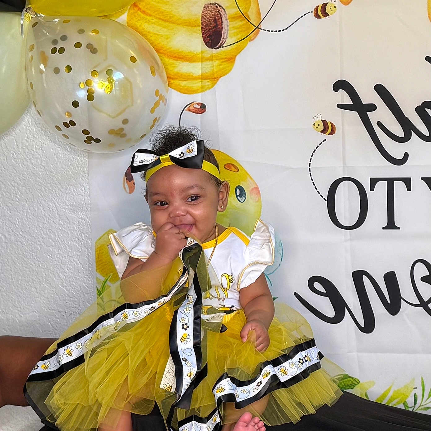 Miheir Harris is registered to the contest to win money with this photo: accessories, baby, balloon, bodypart, clothing, costume, dress, egg, face, finger, food, footwear, hand, hat, head, people, person, photography, portrait, sandal