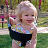 toddler, child, swing, playground, outdoor, smiling, happy, summer_clothing, grass, trees, sunlight, fun, park, young_child, play, feet, hair_bow, daytime, nature, active