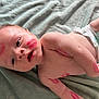 adorable, arm, baby, blanket, child, closeup, cute, diaper, expression, face, human, infant, kiss_marks, lying_down, mark, newborn, pink, red, skin, soft_texture