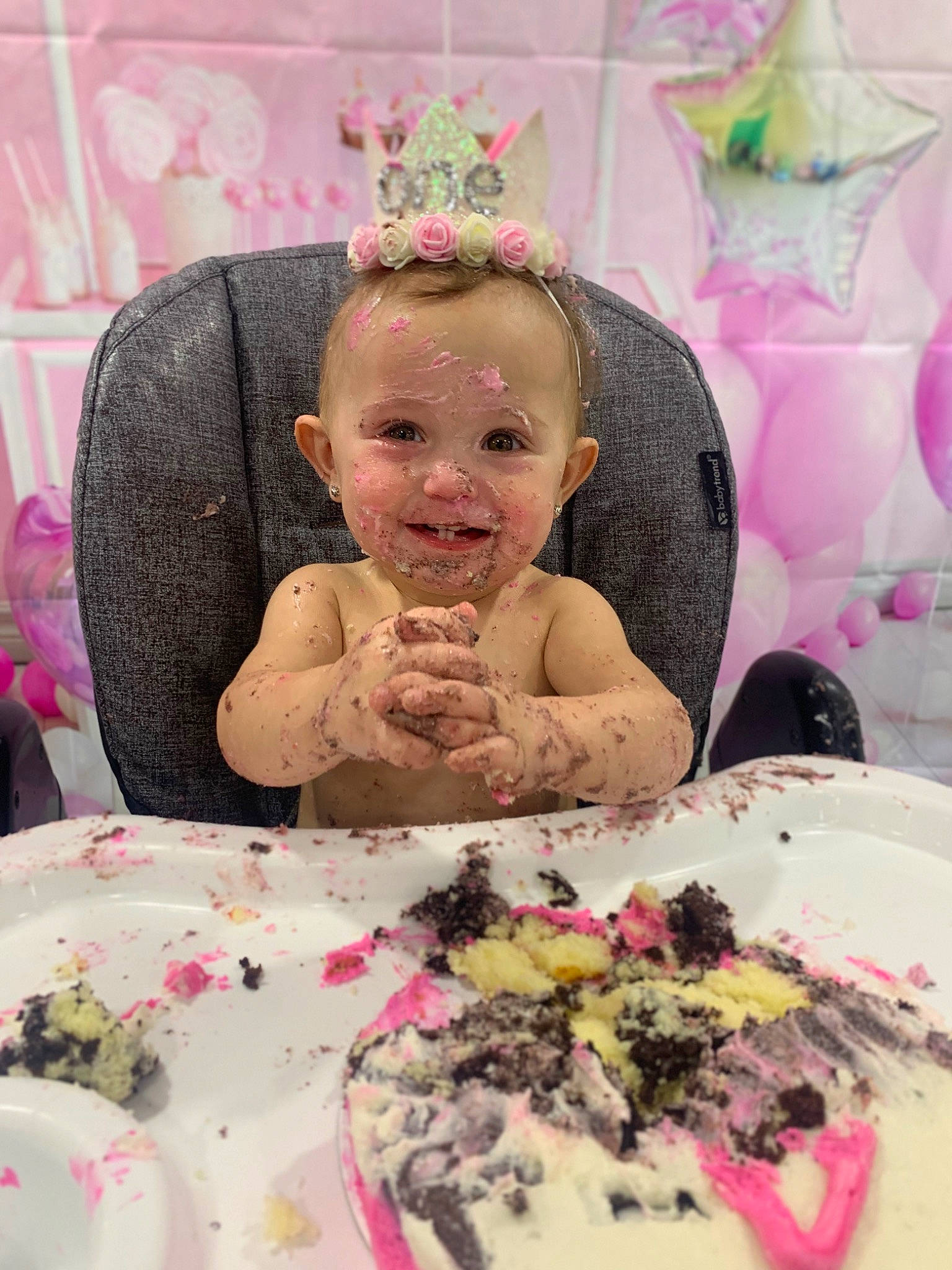Novalee is registered to the contest to win money with this photo: baby, cake, cake_decorating, chair, child, dessert, dishware, face, food, happy, headgear, headpiece, joy, person, pink, plate, recipe, smile, sweetness, table