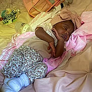 Zoe is registered to the contest to win money with this photo: baby, sleeping, infant, blanket, headband, bow, bottle, pacifier, bed, clothing, pink, white, floral, soft, cozy, rest, cute, child, indoors, portrait