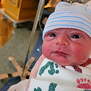Bryan joined the competition — help win amazing prizes! newborn, baby, infant, hospital, hat, striped_hat, swaddle, blanket, feet_print_pattern, face, eyes, cheeks, skin, portrait, close_up, medical_equipment, bassinet, hand, hospital_room, newborn_wrapping