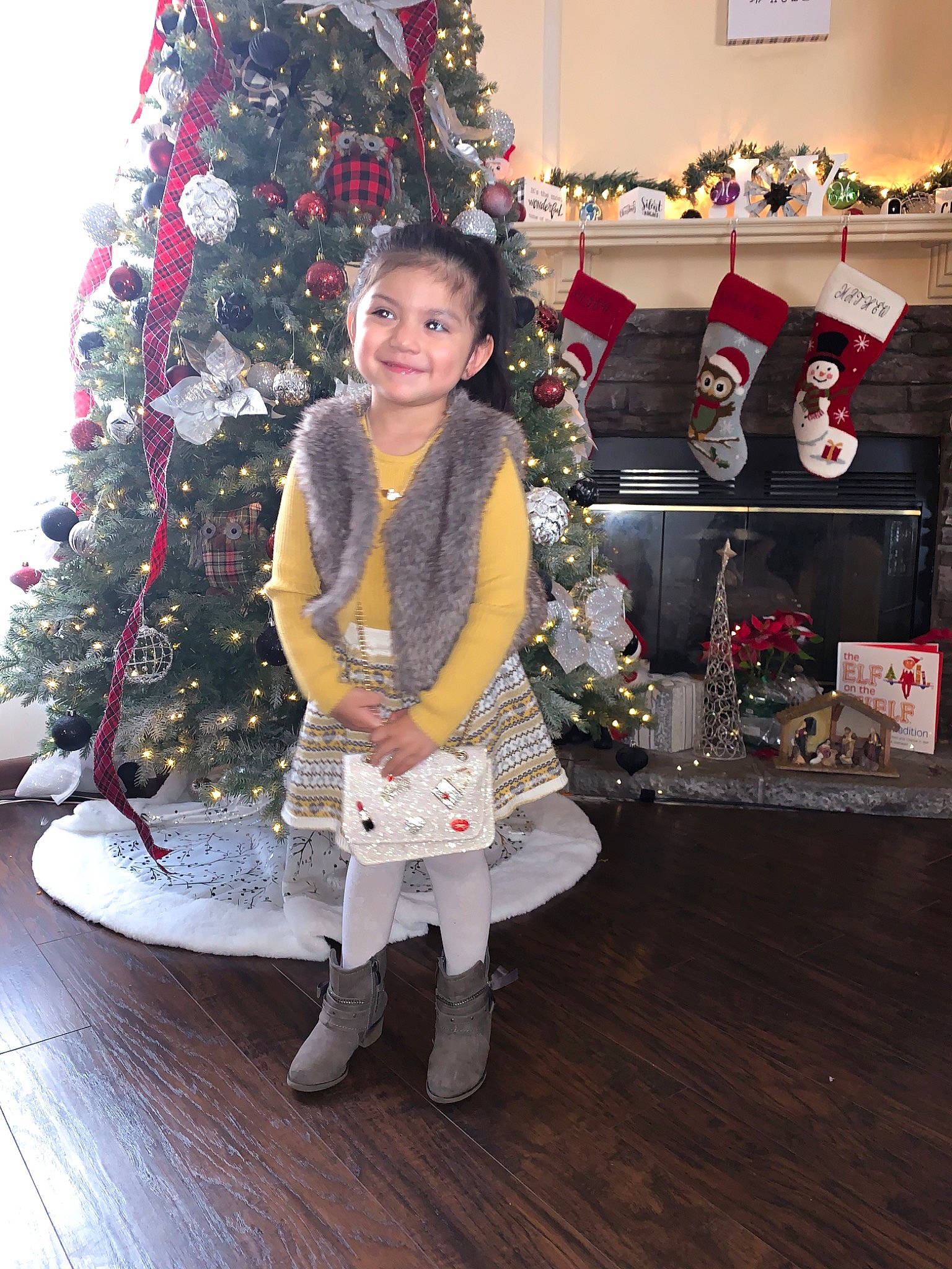 Ariannah is registered to the contest to win money with this photo: christmas, christmas_decoration, christmas_eve, christmas_ornament, christmas_tree, event, holiday, interior_design, joy, person, room, sitting, tree