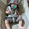 baby, baby_seat, child, clothing, comfort, cute, feet, hand, hooded_clothing, indoor, infant, legs, pacifier, patterned_fabric, portrait, seat, sleepy, soft_lighting, straps, young