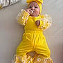 Assia a rejoint le concours — aidez-le/la à gagner de superbes lots ! baby, yellow_clothing, pacifier, headband, daisy_pattern, infant, cute, lying_down, soft_surface, adorable, child, bright_colors, baby_fashion, portrait, indoor, baby_girl, headwear, baby_outfit, small_hands, comfort