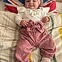 Assia a rejoint le concours — aidez-le/la à gagner de superbes lots ! baby, infant, pink_clothing, headband, smile, pillow, union_jack, bed, blanket, footwear, shoes, cute, child, portrait, happy, indoor, person, fashion, sleepwear, resting
