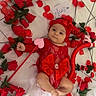adorable, baby, blanket, bow, child, costume, cute, floral, headband, heart_prop, infant, lying_on_bed, newborn, photography, portrait, props, red_dress, rose_petals, roses, valentine