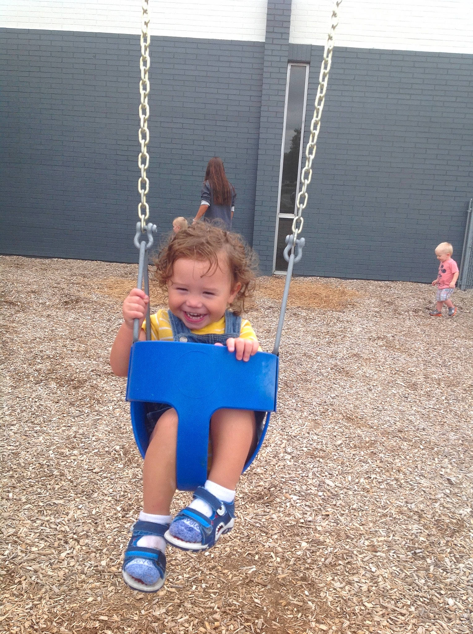 Carter James is registered to the contest to win money with this photo: child, city, fun, human_settlement, joy, outdoor_play_equipment, person, play, playground, public_space, recreation, smile, summer, swing, toddler, vacation