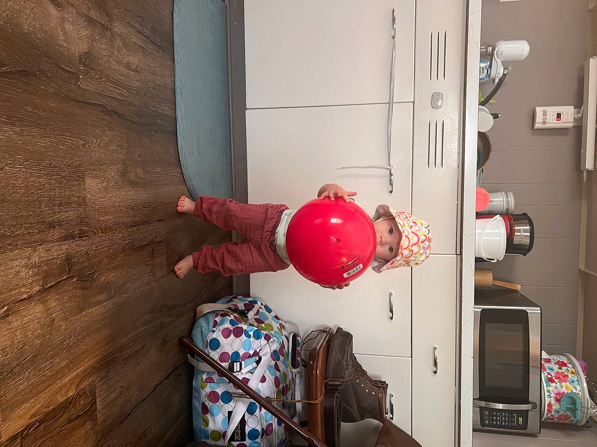 Izabella joined the competition — help win amazing prizes! ball, carmine, door, door_handle, drum, floor, flooring, football, gas, hardwood, headwear, helmet, home_appliance, home_door, living_room, machine, person, personal_protective_equipment, plant, room
