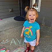 Ava is registered to the contest to win money with this photo: blue_shirt, chalk, child, concrete, door, giraffe_print, girl, happy, outdoor, pigtails, pink_boots, playful, porch, rainbow, sidewalk, smiley_face, toddler, tongue_out, welcome_sign, white_shorts