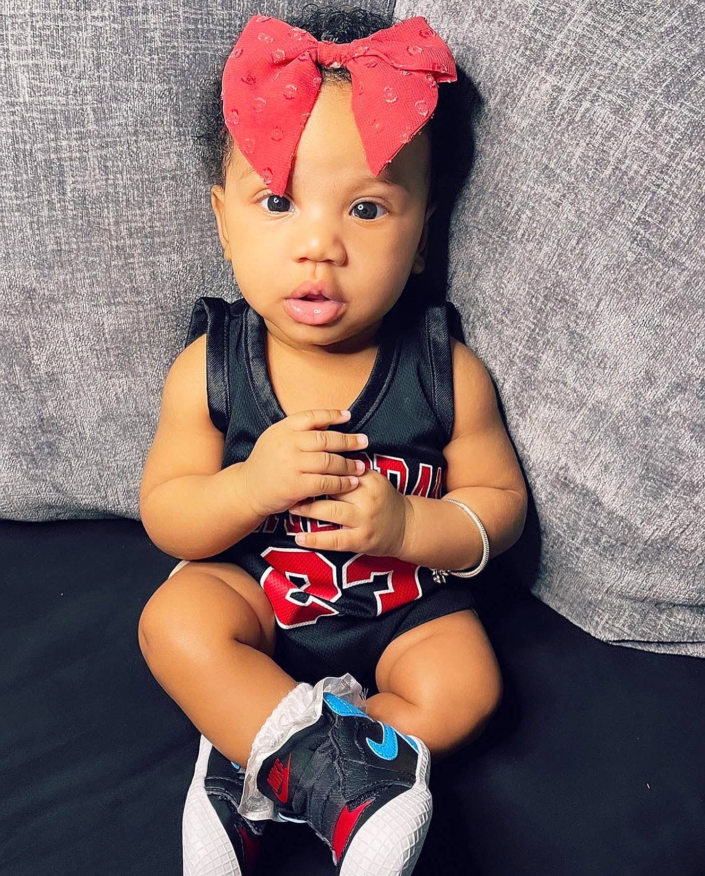 Italy is registered to the contest to win money with this photo: baby, baby_toddler_clothing, beauty, black_hair, cap, costume_hat, eye, happy, hat, headwear, human_body, human_leg, knee, lip, neck, person, sleeve, sportswear, t_shirt, textile