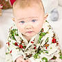 Finley is registered to the contest to win money with this photo: baby, blue_eyes, child, christmas, cozy, cute, face, green, hands, holiday, indoor, infant, looking_up, pajamas, patterned_clothing, portrait, red, sitting, toy, white