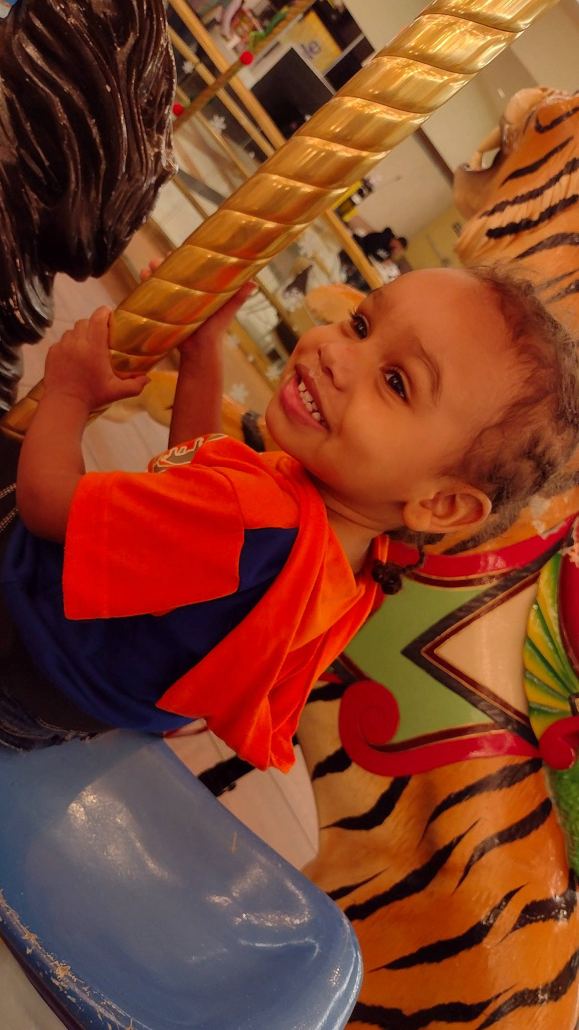 Prince is registered to the contest to win money with this photo: baby, child, comfort, event, fun, happy, joy, laugh, leisure, orange, organ, person, play, recreation, room, sitting, smile, t_shirt, toddler, vacation