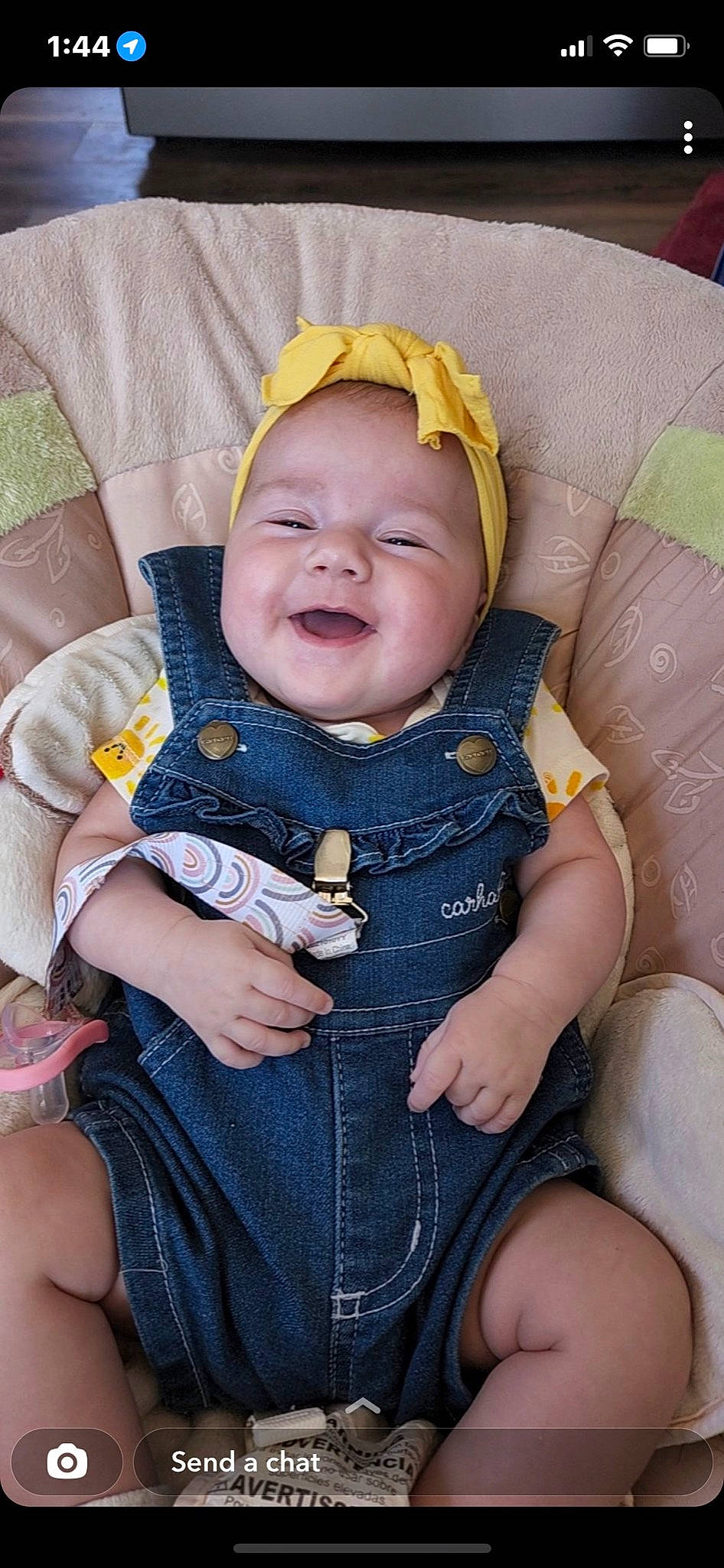 Maggie is registered to the contest to win money with this photo: baby, baby_toddler_clothing, chair, cheek, comfort, dress, eye, face, facial_expression, finger, head, iris, lap, person, pink, product, purple, skin, sleeve, smile