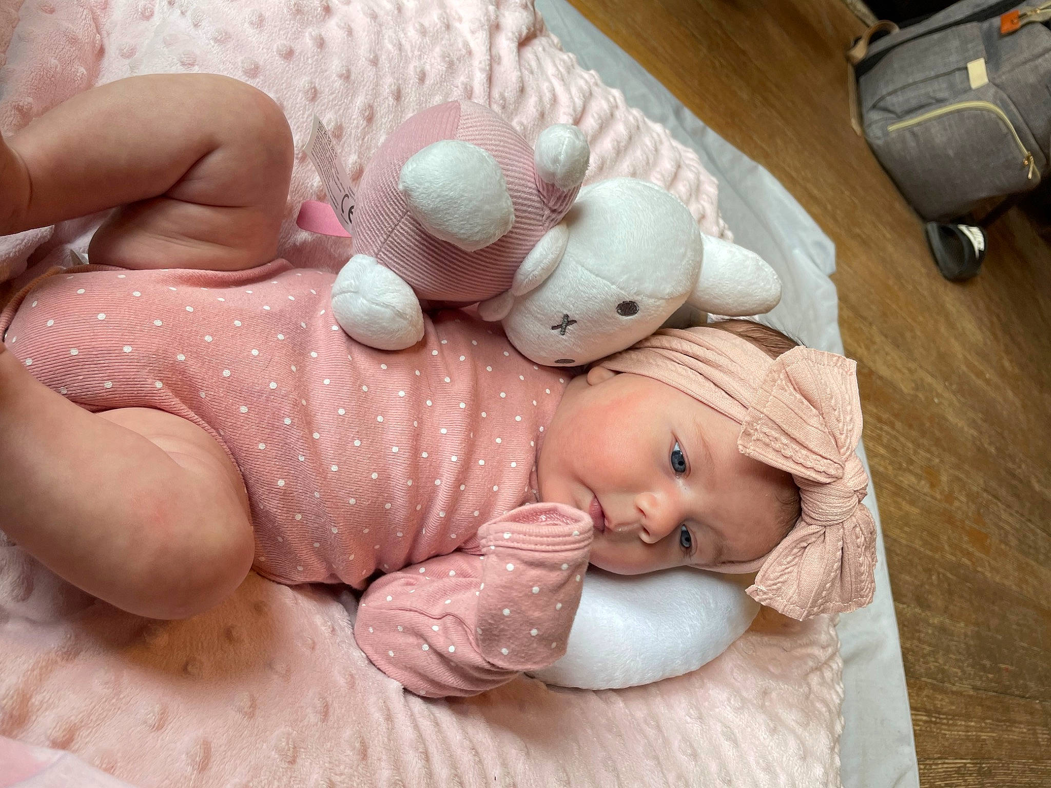 Maggie joined the competition — help win amazing prizes! baby, backpack, bag, cap, child, comfort, doll, finger, flooring, gesture, headwear, linens, luggage_and_bags, nail, person, pink, skin, stuffed_toy, thumb, toddler