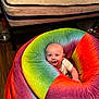 Malachi joined the competition — help win amazing prizes! baby, bean_bag, rainbow, colorful, smiling, indoor, floor, mattress, baby_bottle, wood_floor, furniture, child, person, happy, soft, seat, cushion, head, cute, cozy