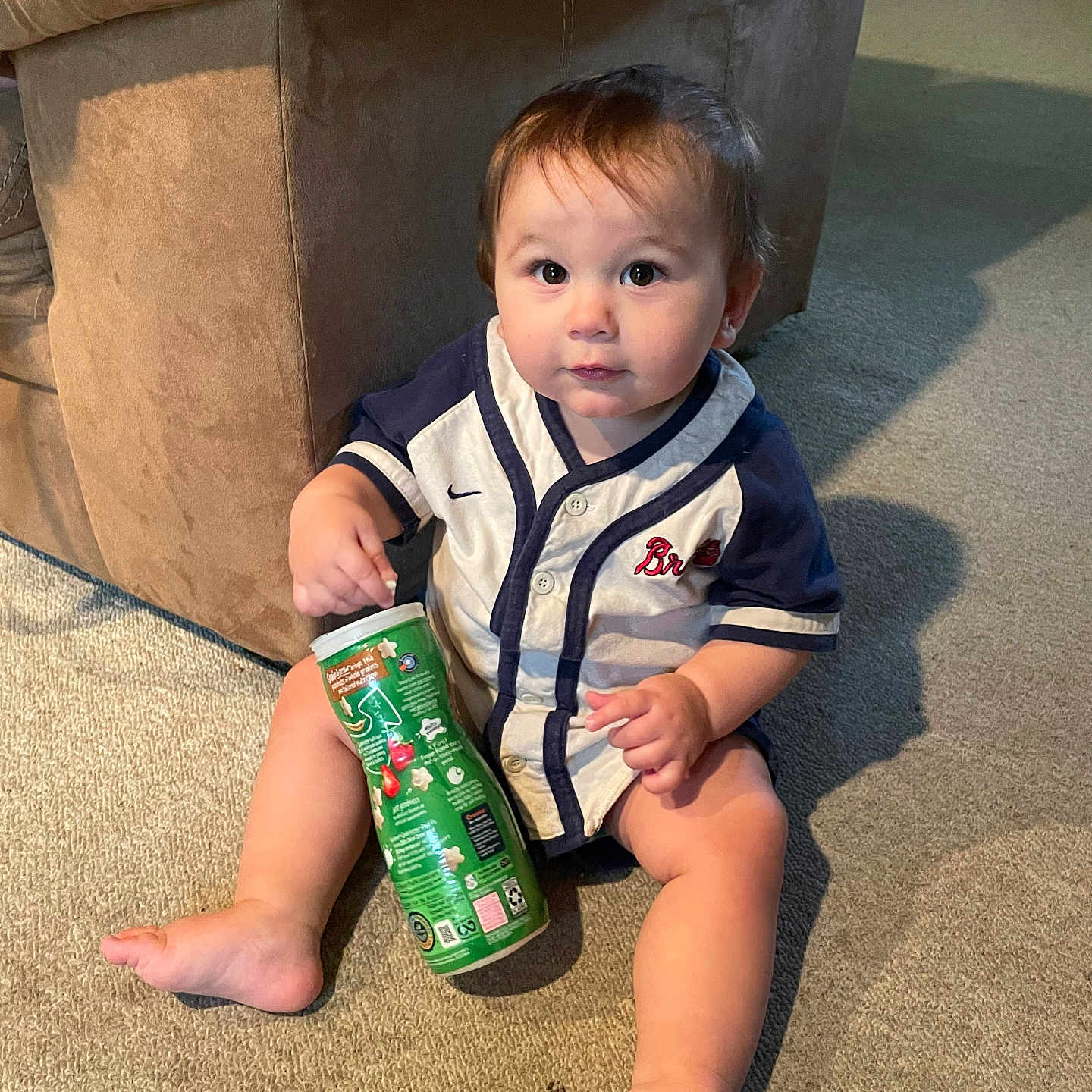 Travis is registered to the contest to win money with this photo: architecture, baby, bottle, building, can, clothing, couch, face, furniture, head, indoors, interiordesign, livingroom, person, photography, portrait, room, shorts, sitting, tin