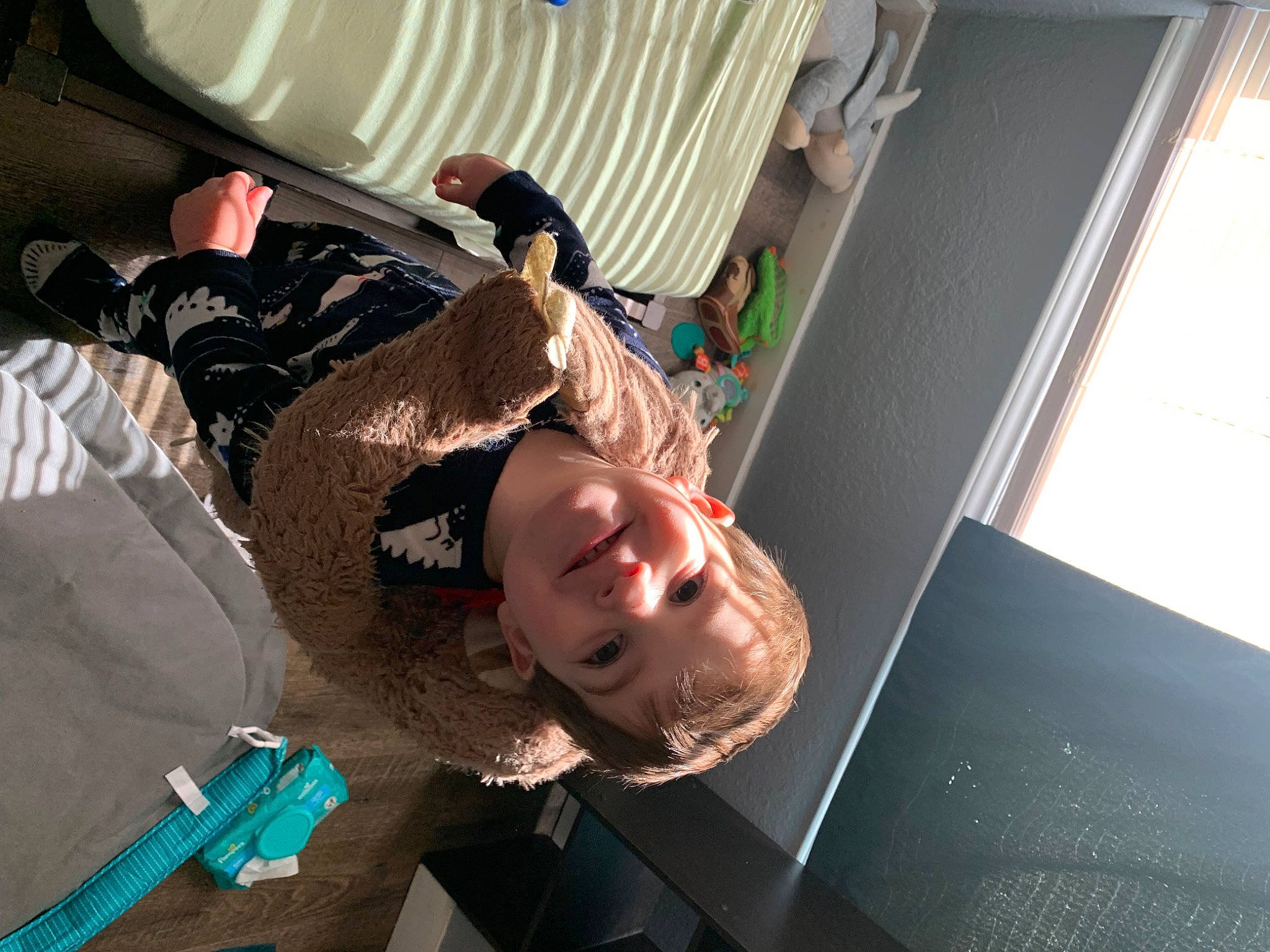 Zane is registered to the contest to win money with this photo: child, comfort, curtain, flooring, fun, joy, person, room, smile, t_shirt, toddler, wood