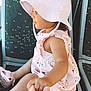 toddler, child, hat, pink_dress, bus_seat, hand_holding, sunlight, footwear, public_transport, side_view, indoor, casual_clothing, cute, small_child, person, seated, window_light, skin, portrait, baby_shoes