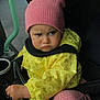toddler, child, stroller, pink_hat, yellow_jacket, banana_pattern, grumpy_face, baby, cold_weather_clothing, blanket, outdoor, seat, hand, expression, person, cute, warm_clothing, infant, transport, wearing